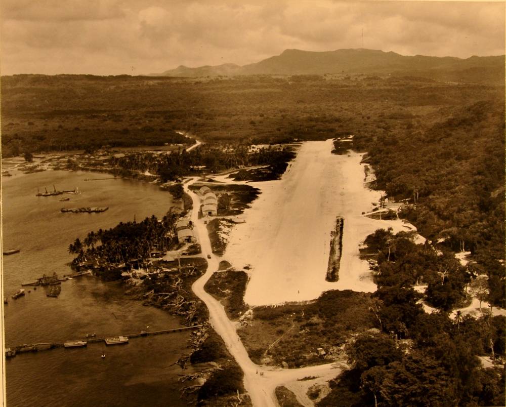 Aerial photo of the Havannah Harbor airstrip in 1943, with Quonset hangars and boats along the harbour